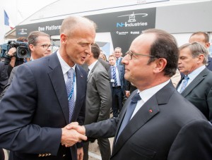 French President François Hollande (right) is welcomed by Airbus Group CEO Tom Enders (left) at the company’s static display.
